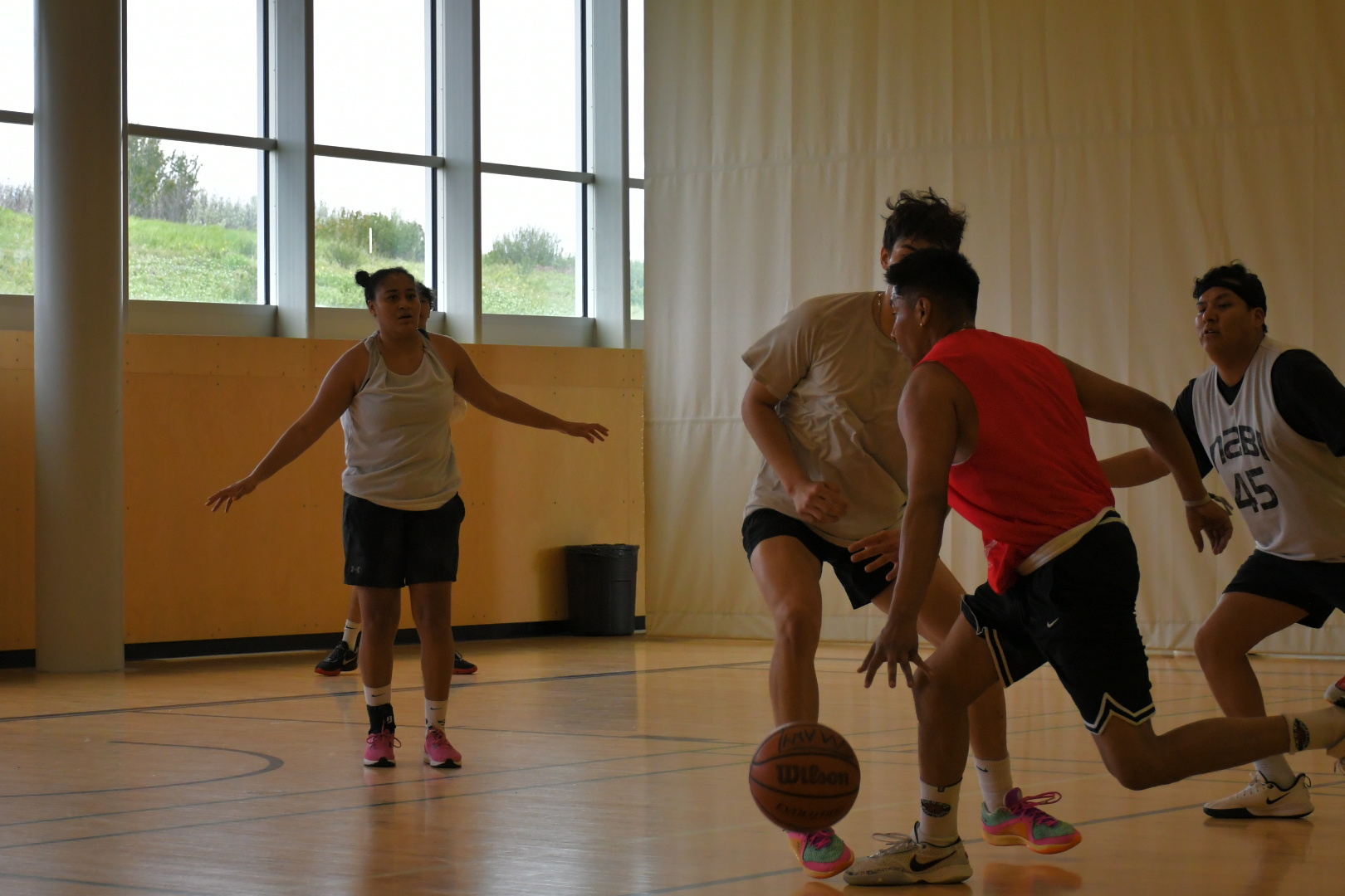 A group of youth play basketball