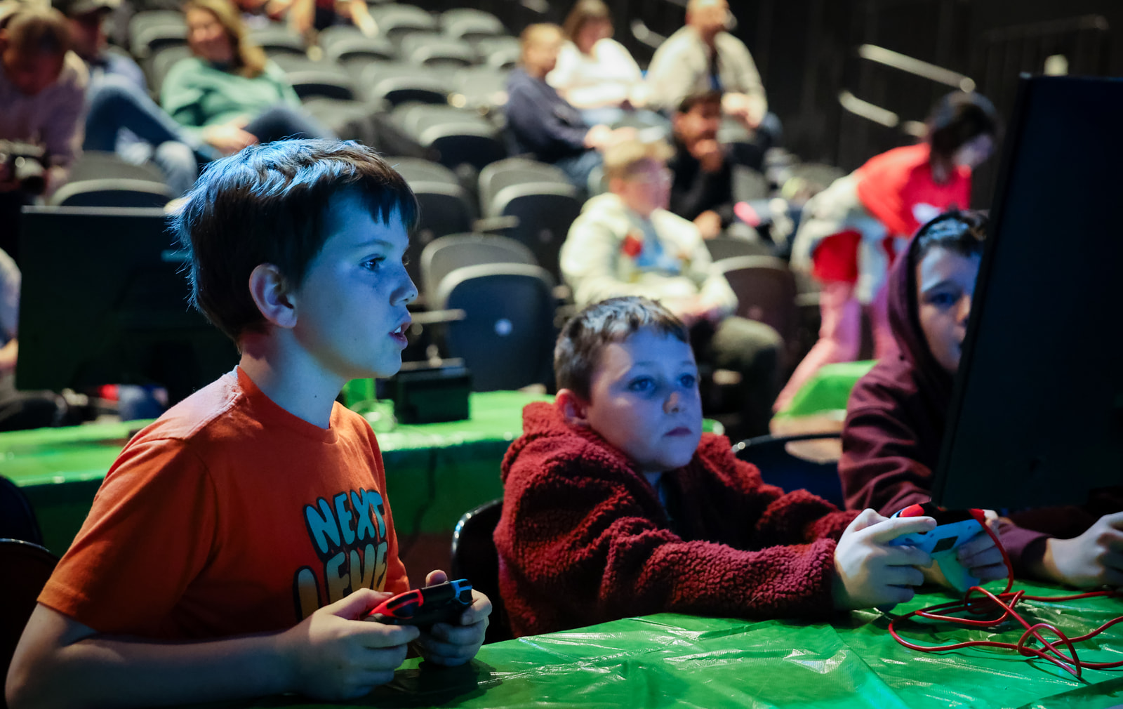 A group of three youth play Switch as part of a YMCA esports tournament