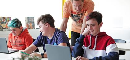 group of youth working on computers