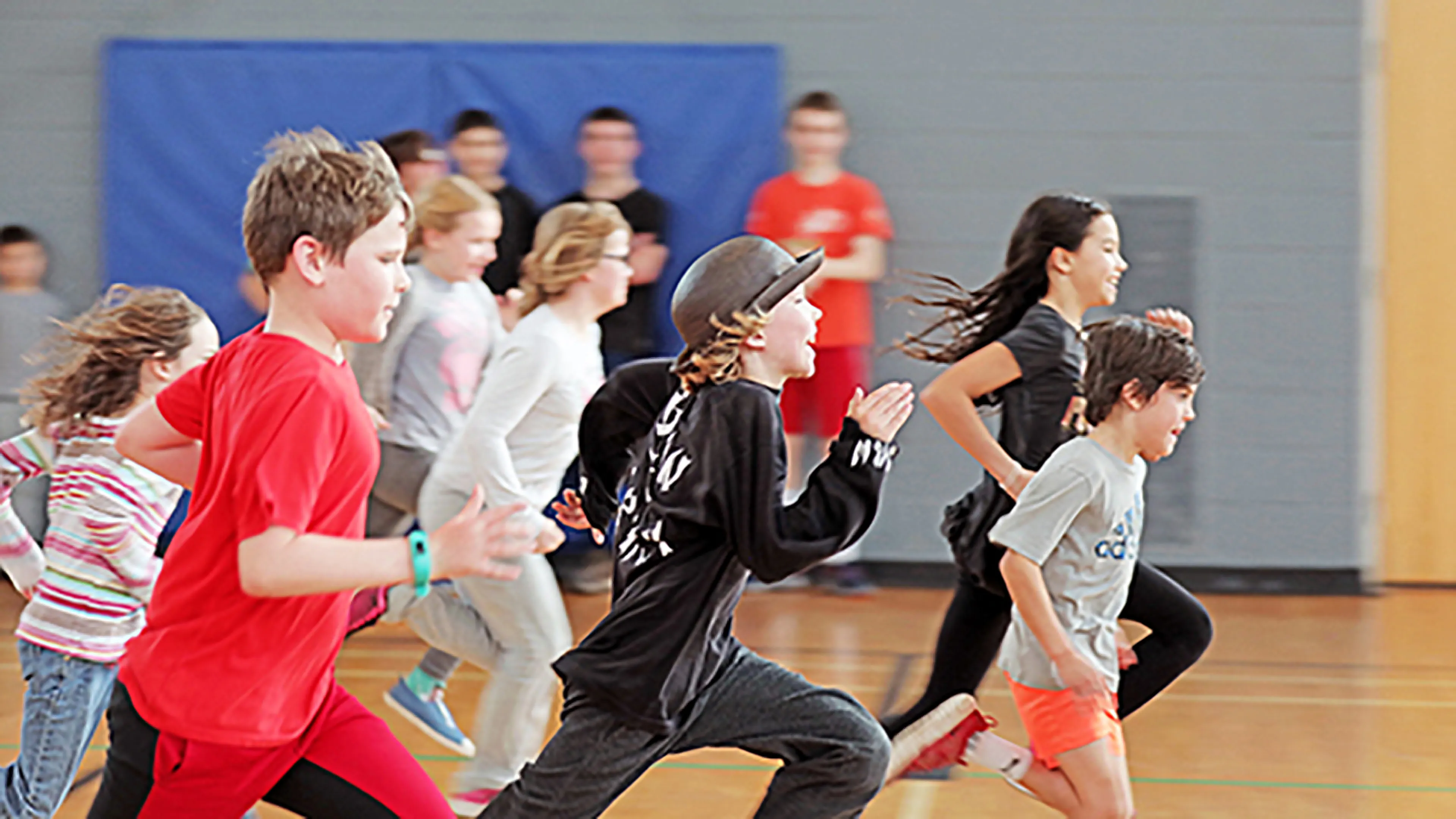 large group of youth running in gym