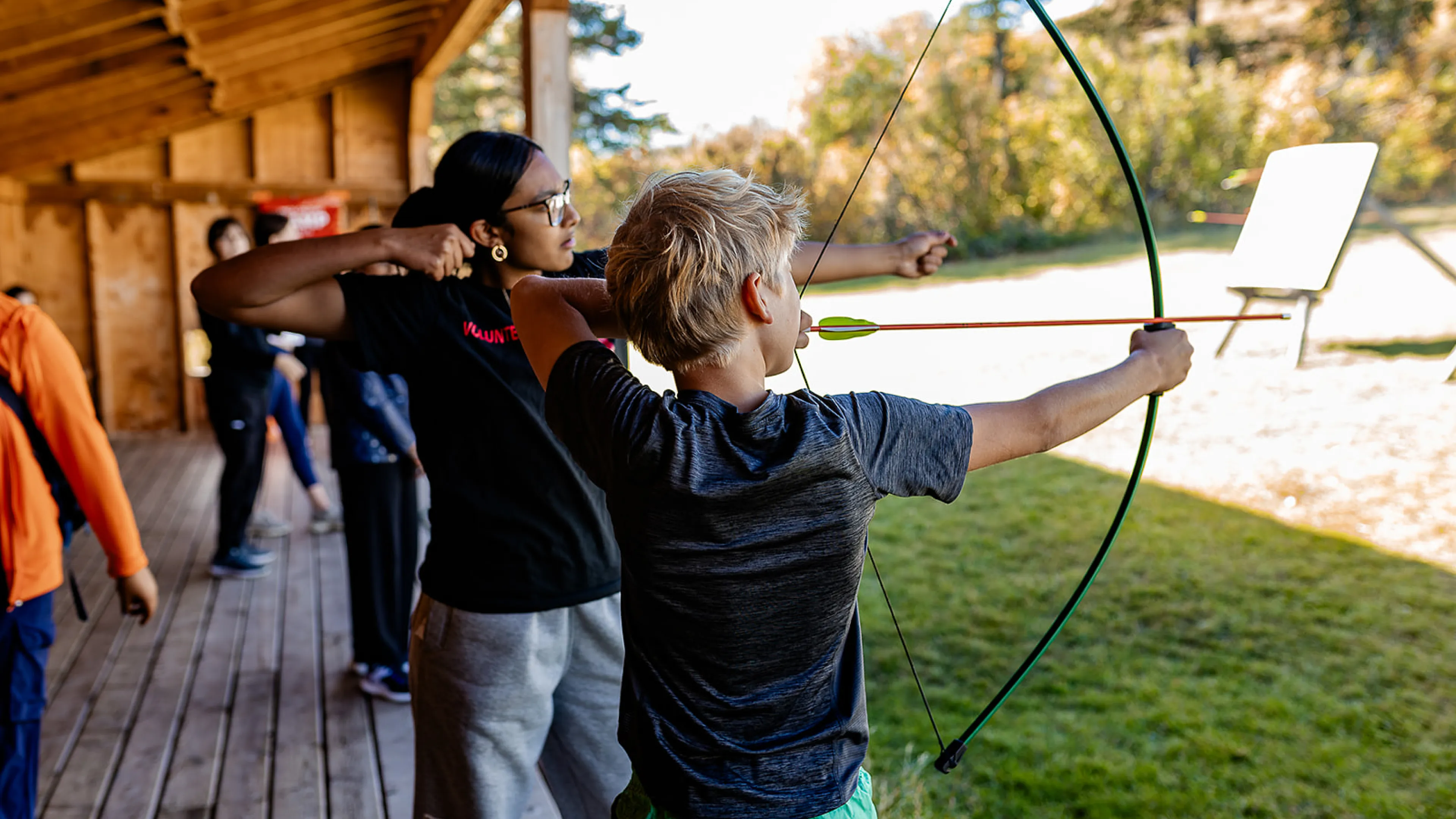 Youth shooting arrow at Camp Riveredge YMCA