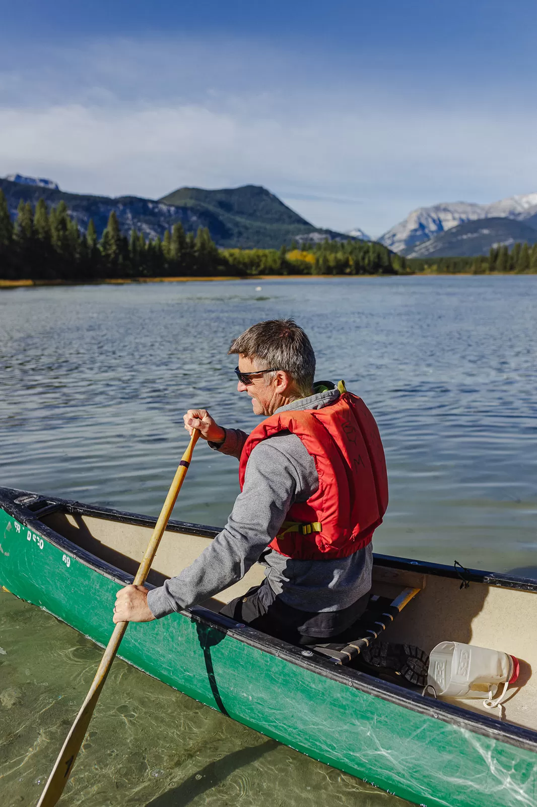 A man paddles in a canoe at Camp Chief Hector