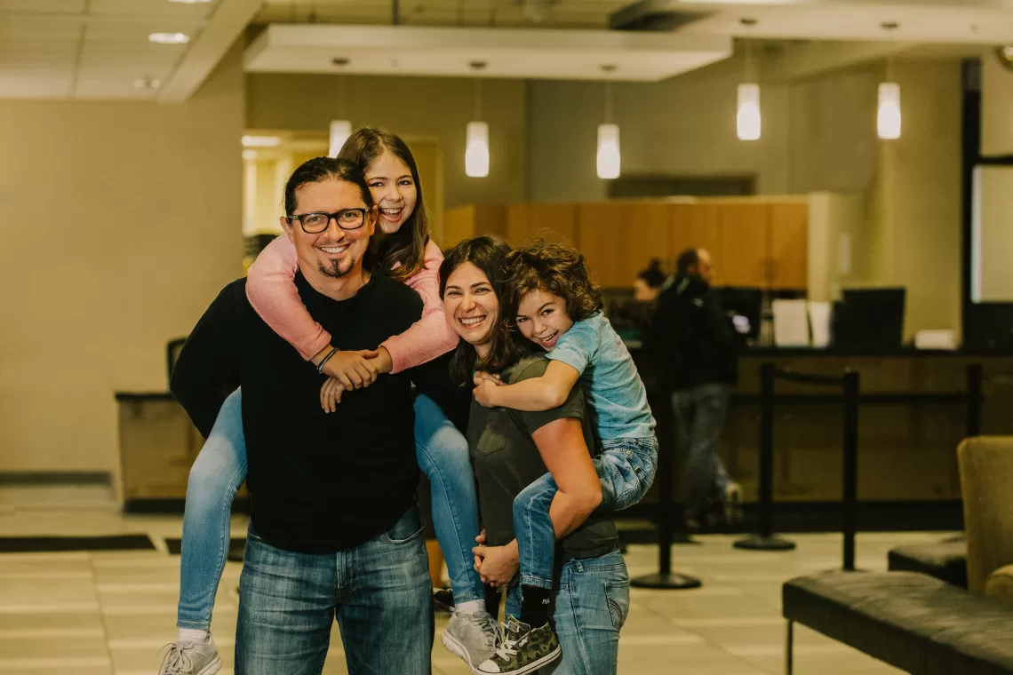 A family of four smiling